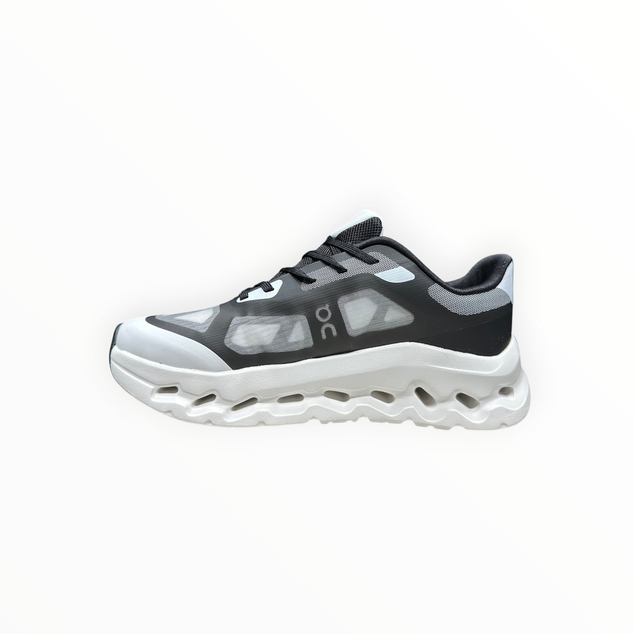 EWW Sports Shoes black and white On Cloudtilt Remix running shoe with see-through upper and chunky white sole.