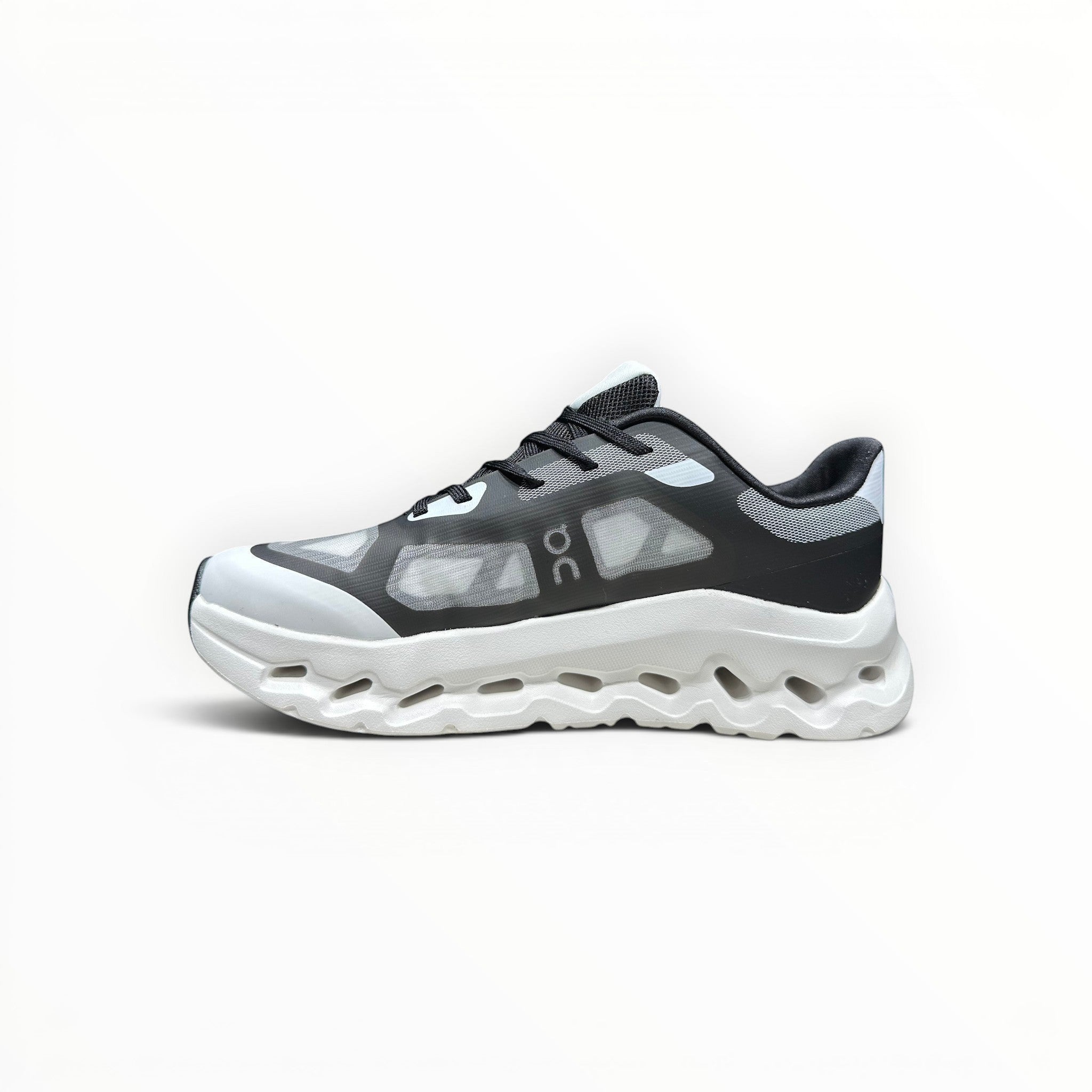 EWW Sports Shoes black and white On Cloudtilt Remix running shoe with see-through upper and chunky white sole.