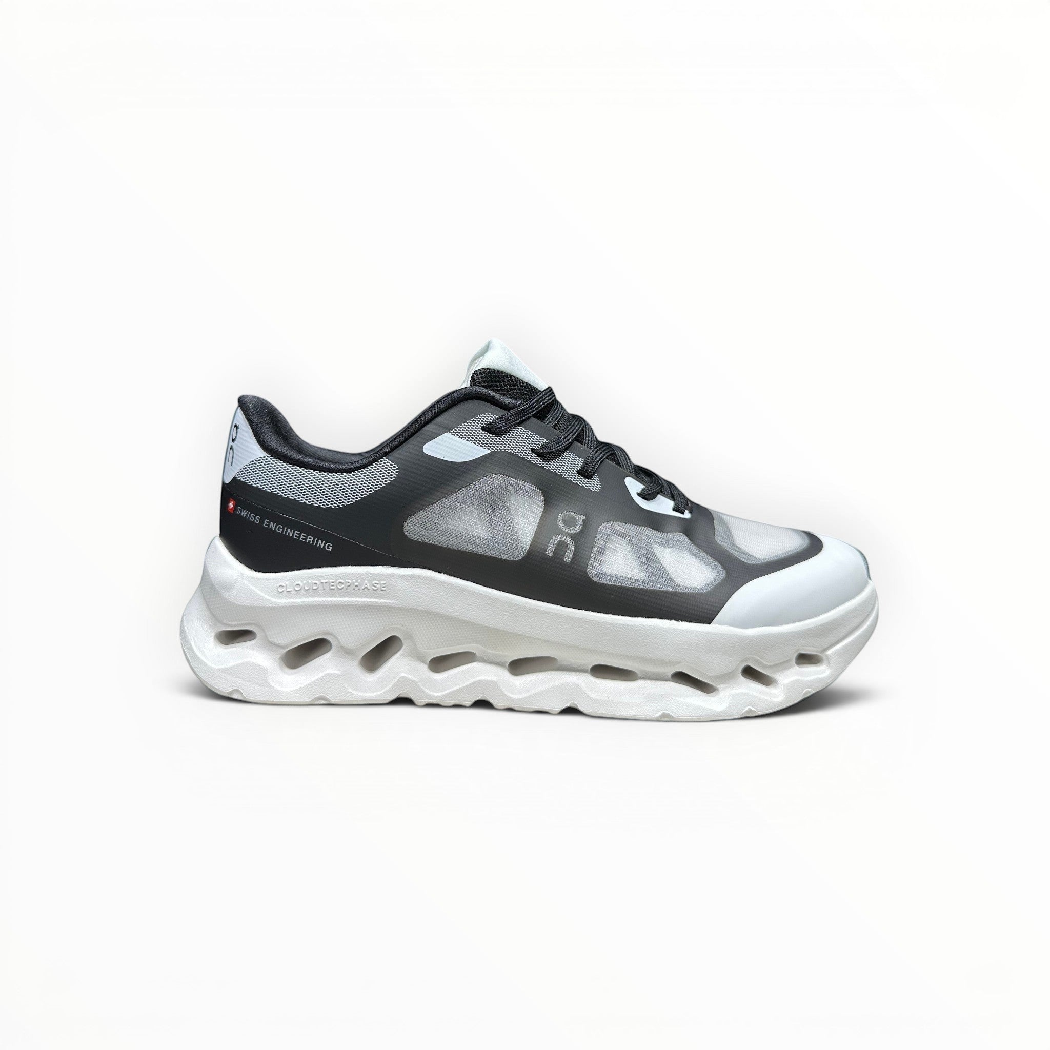 EWW Sports Shoes On Cloudtilt Remix women's running sneaker in black and white with a layered x-ray mesh upper.