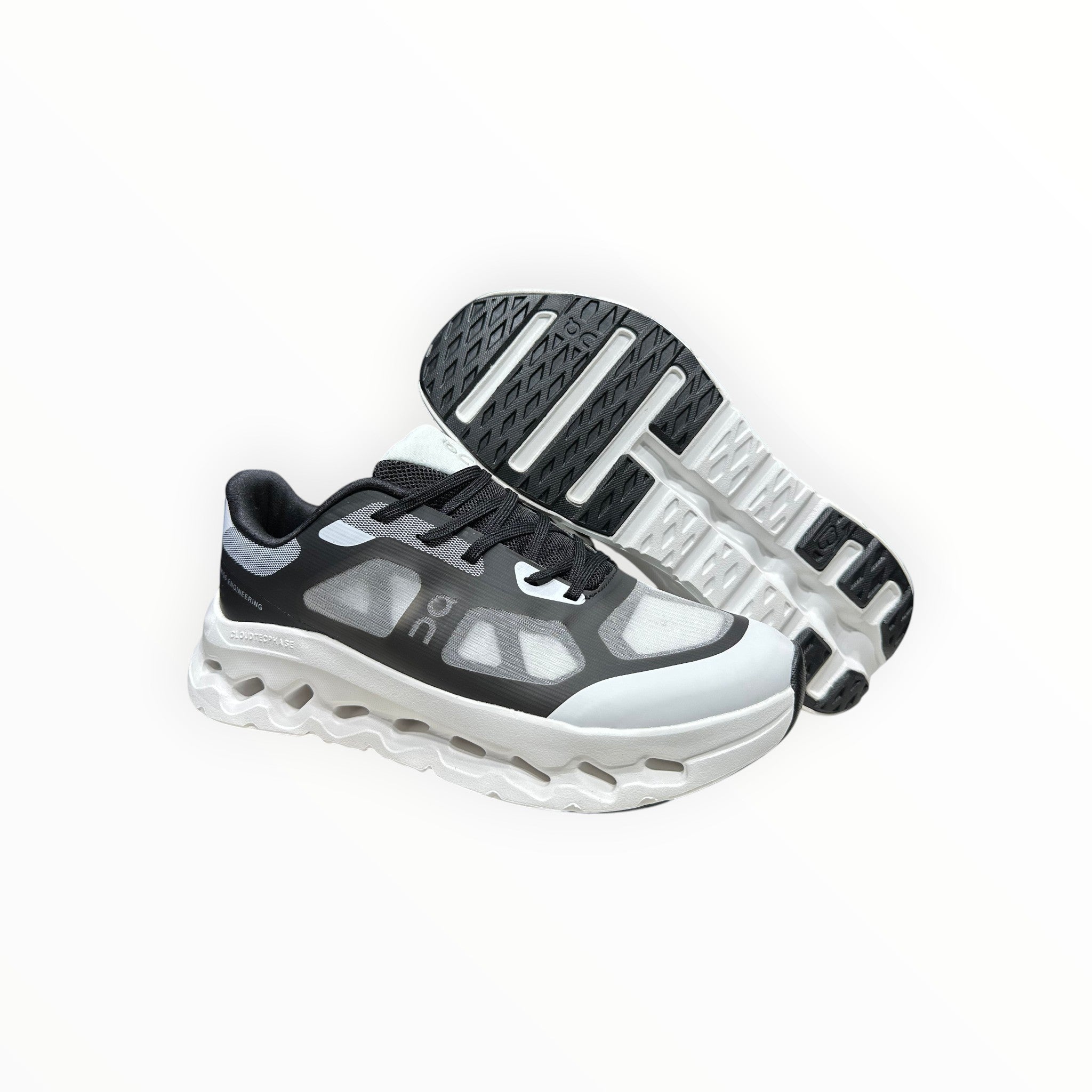 EWW Sports Shoes black and white On Cloudtilt Remix running shoes with see-through upper and white sculpted midsole.