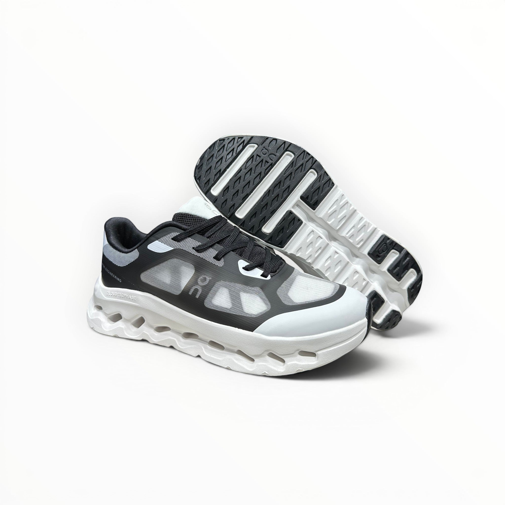 EWW Sports Shoes black and white On Cloudtilt Remix running shoes with see-through upper and white sculpted midsole.
