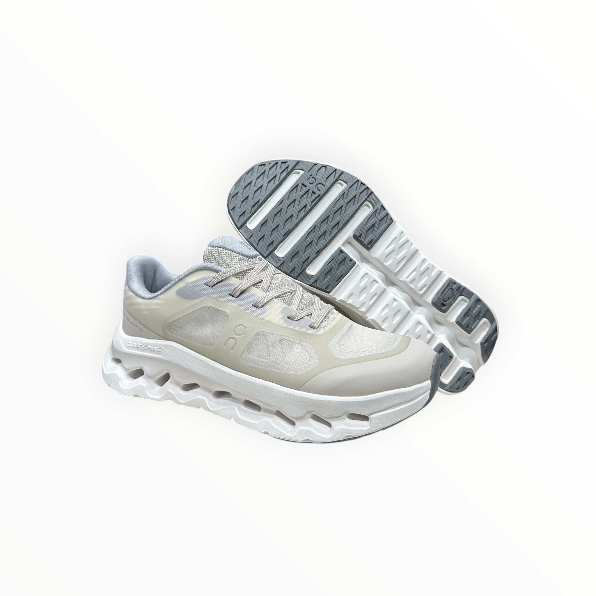 EWW Sports Shoes On Cloudtilt Remix cream running shoes with layered see-through upper and white chunky sole.