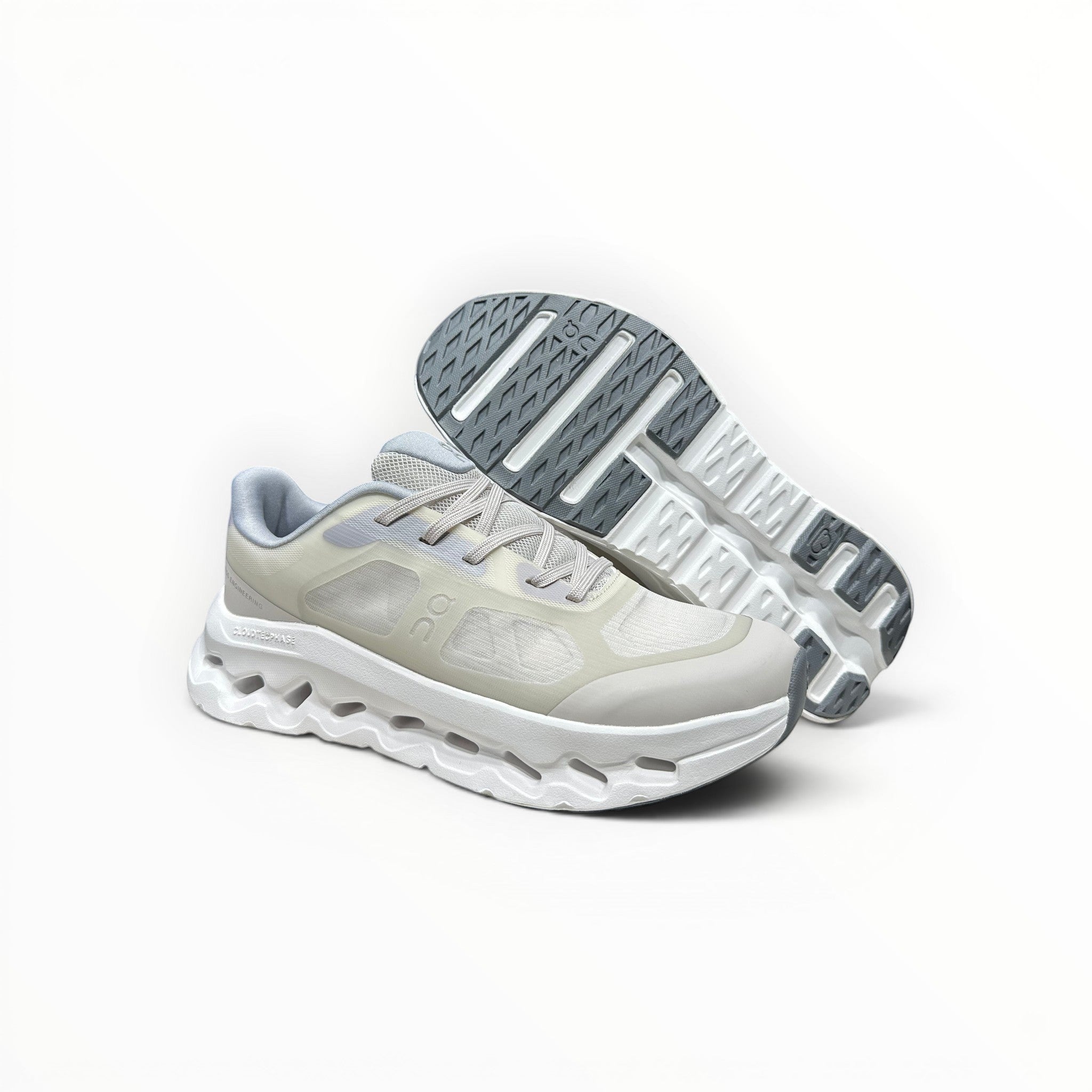 EWW Sports Shoes On Cloudtilt Remix cream running shoes with layered see-through upper and white chunky sole.