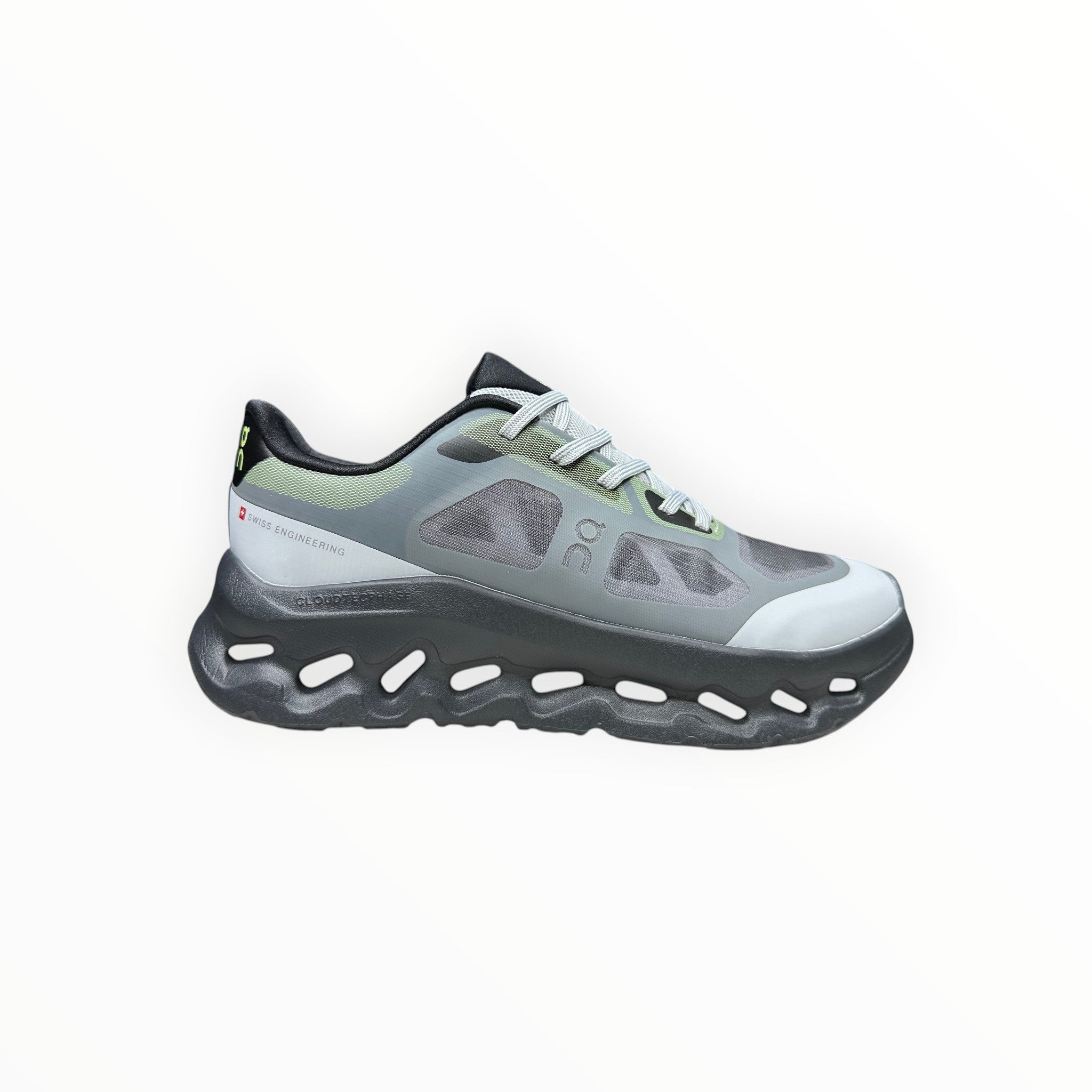 EWW Sports Shoes On Cloudtilt Remix grey and black running shoe with see-through upper and chunky sole.